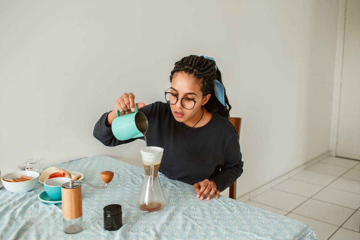 Glass pour-over coffee brewer with a wooden collar