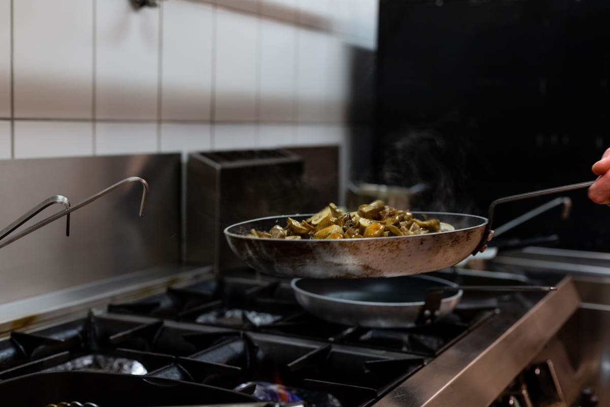 Frying pan on a stovetop photographed from above