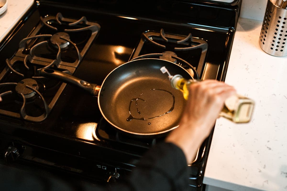 Two ceramic-coated frying pans on a plain surface