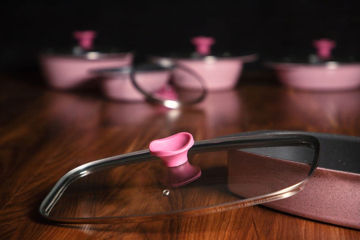 Two ceramic-coated pans side by side on a plain surface