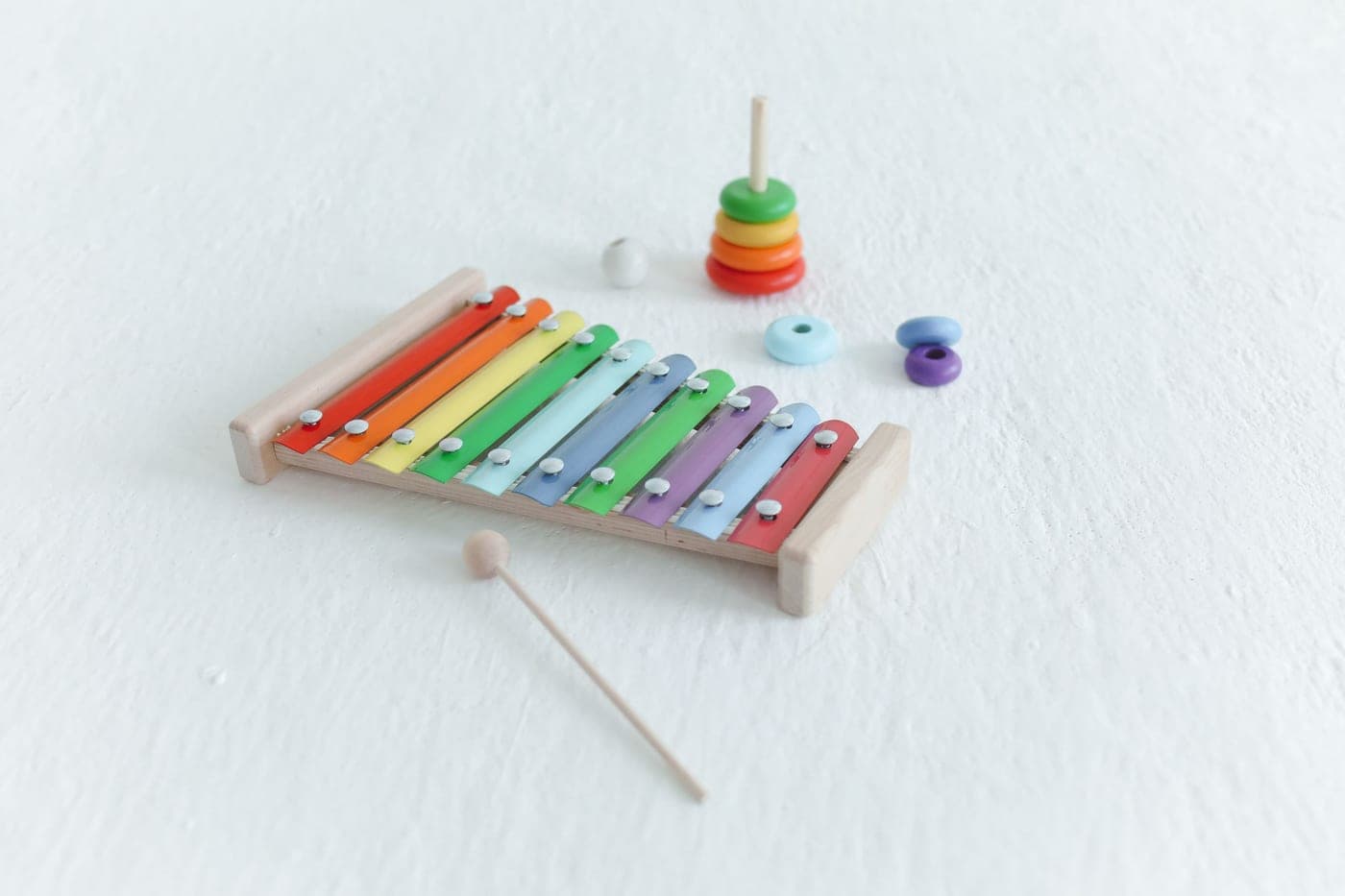 Wooden baby toys arranged on a plain light background