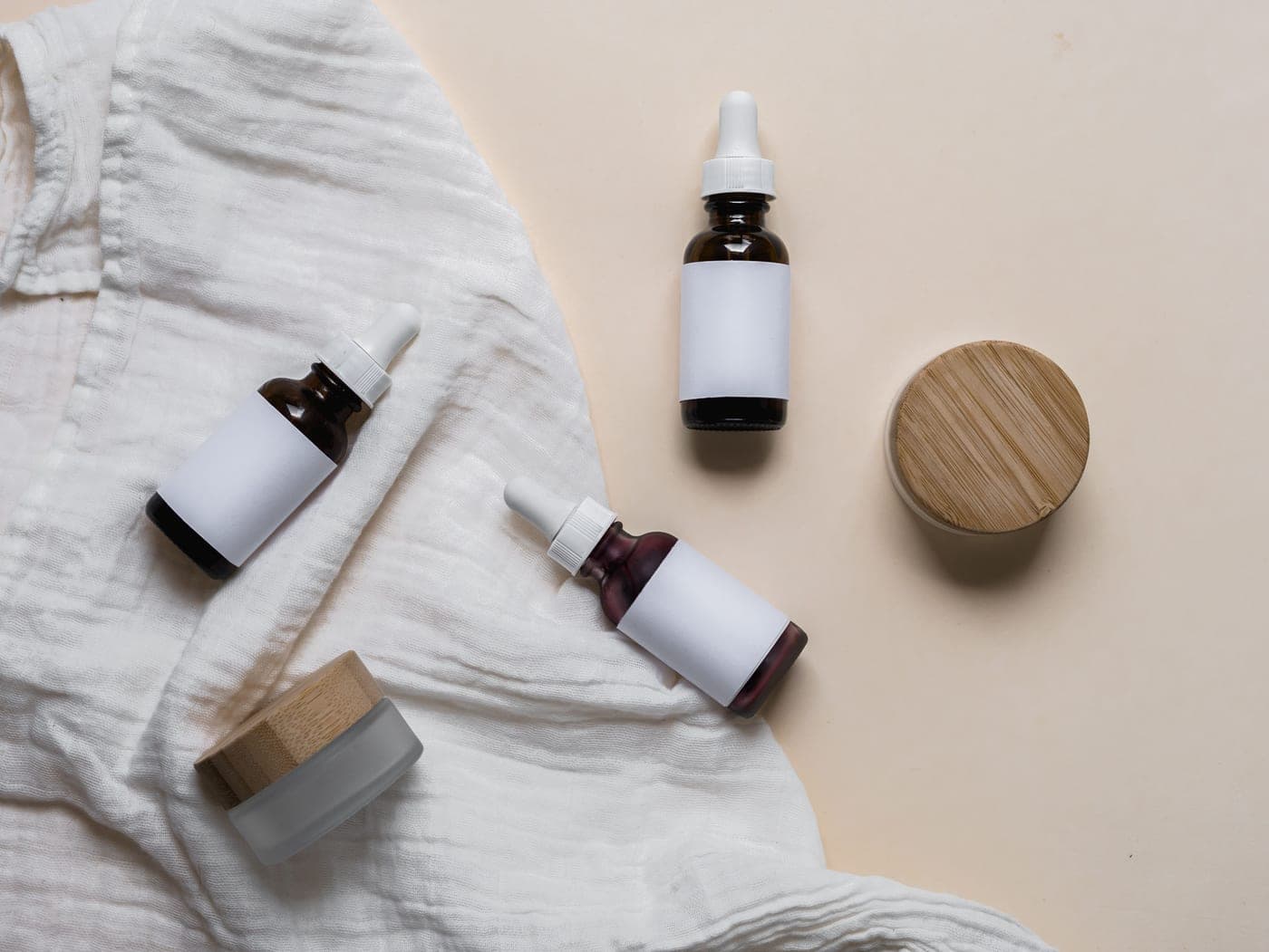 Minimal skincare and deodorant containers on a white surface