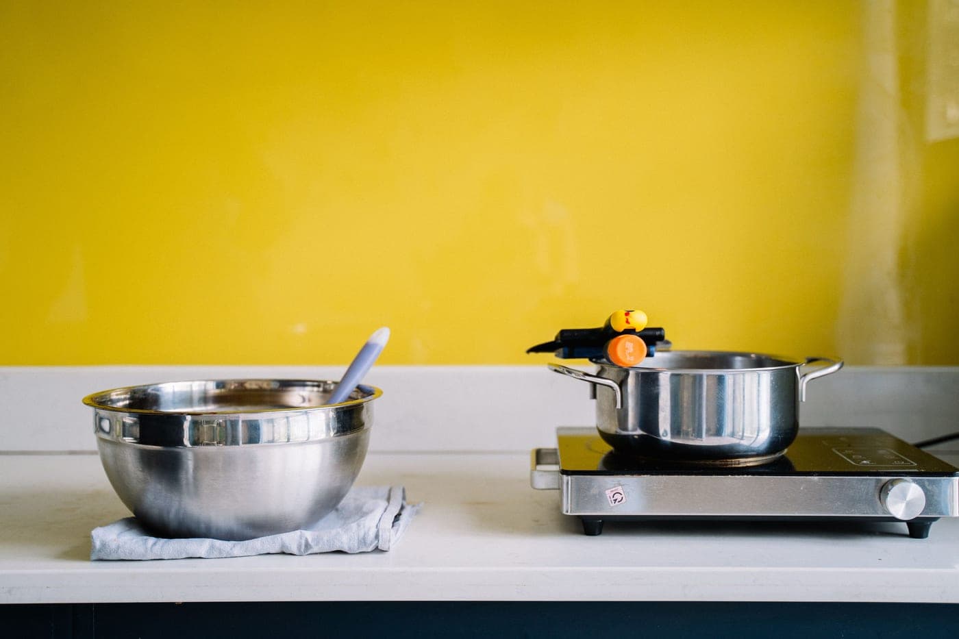 Stainless steel saucepan photographed straight-on under hard light