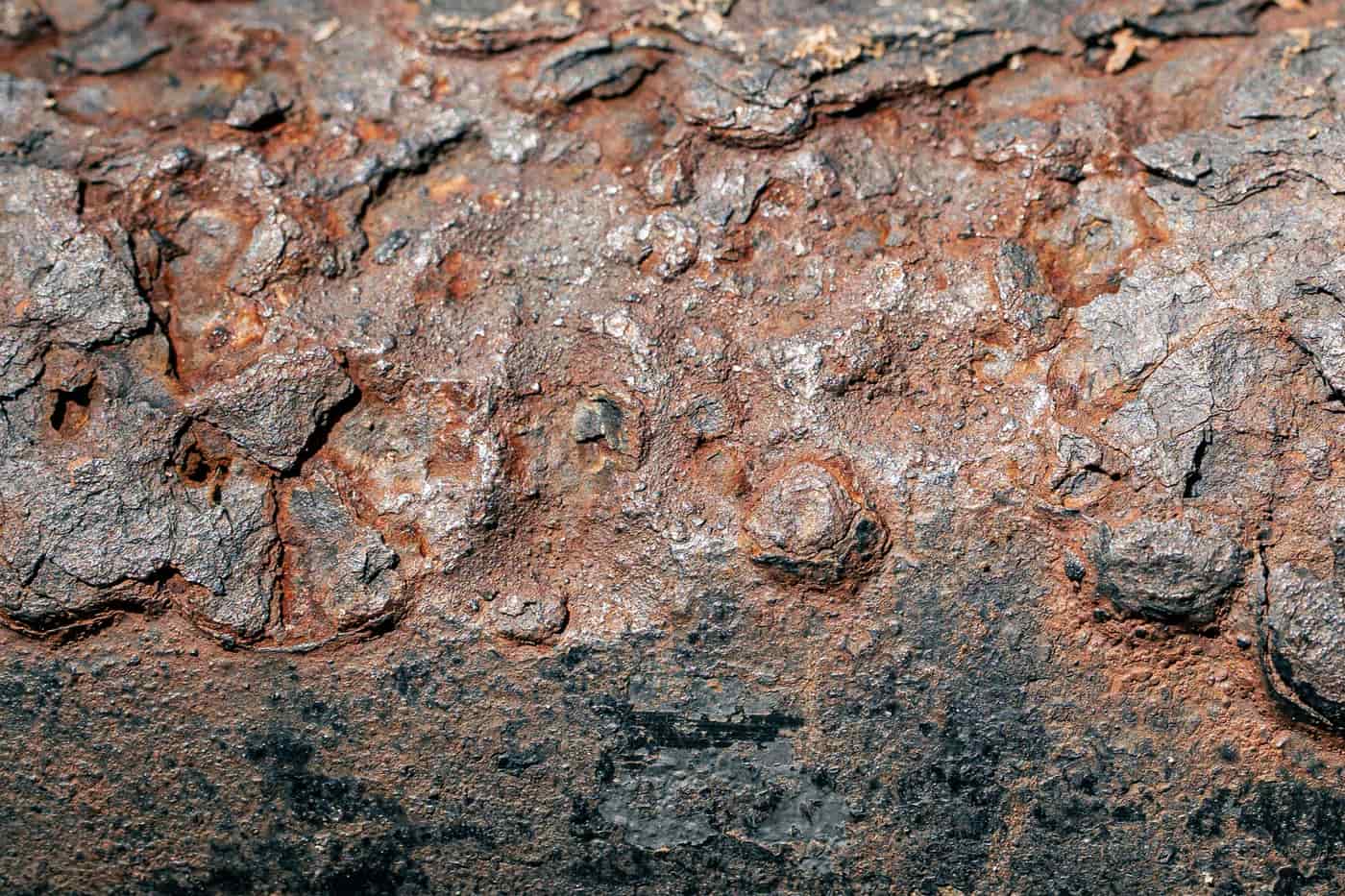 Close-up of brushed metal surface texture under hard light