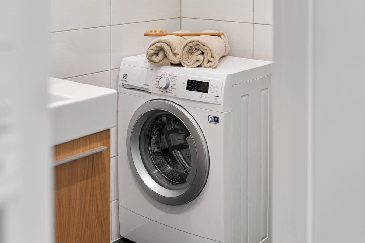 Laundry powder tub beside folded towels