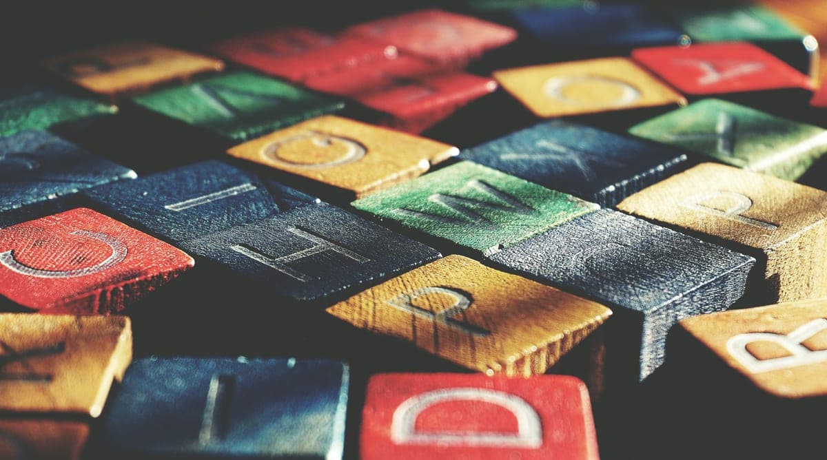 Wooden toy blocks stacked on a plain background