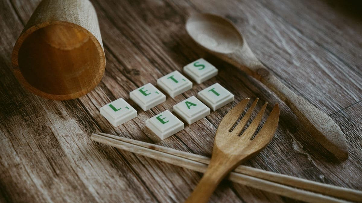 Wooden and steel kitchen utensils standing in a crock