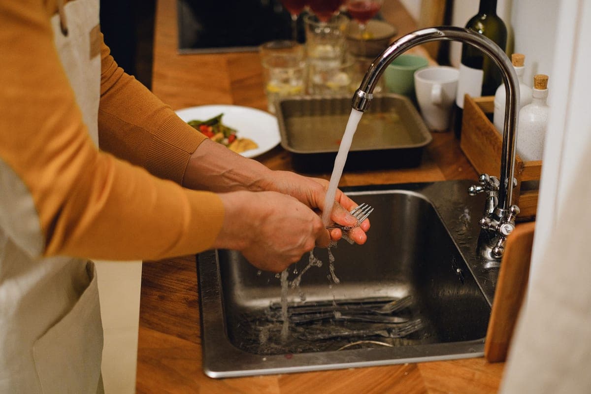 Jug of cleaning vinegar with baking soda on a counter