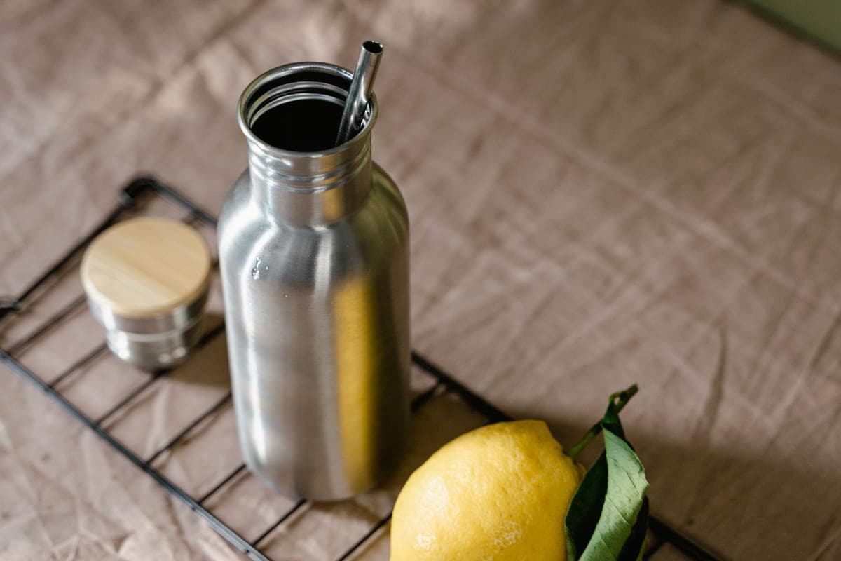 Stainless steel and glass water bottles side by side
